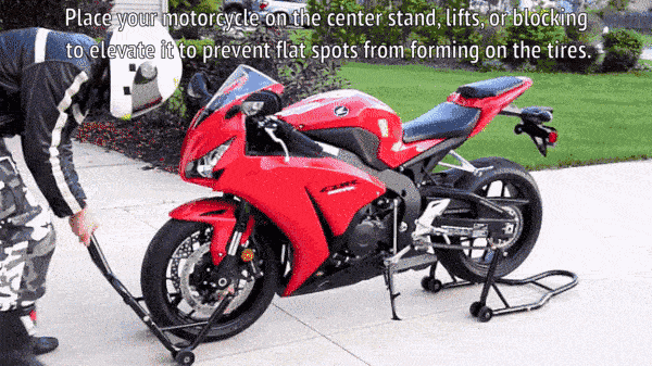 A motorcycle owner using a center stand to elevate the bike, and prevent flat spots on tires. 