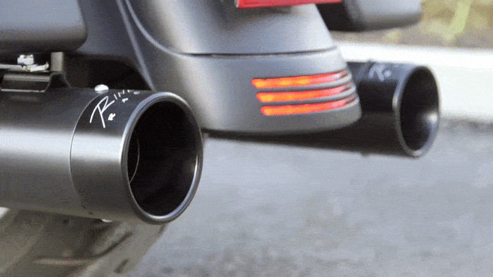 A shot of a motorcycles exhaust as it fires up. 