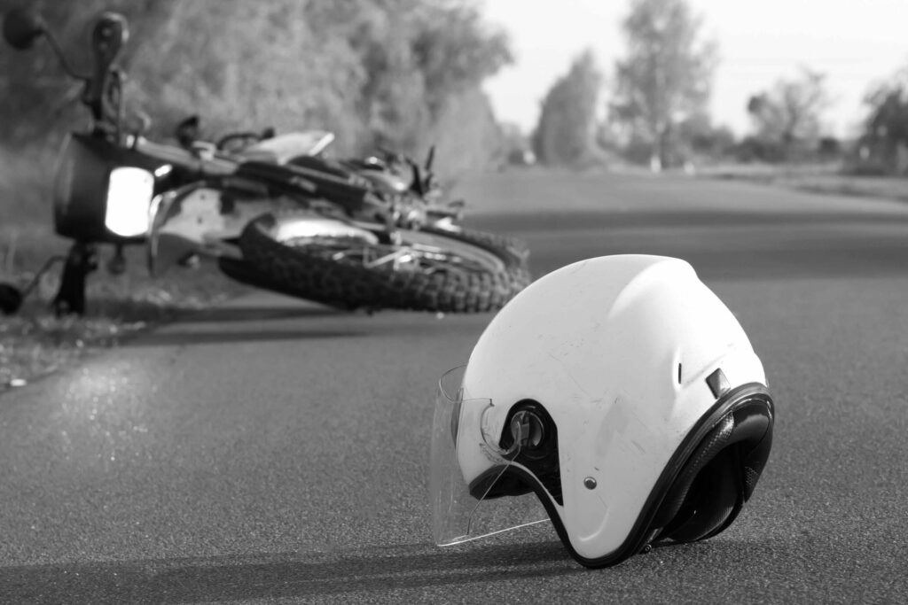 Crashed motorcycle with helmet on road