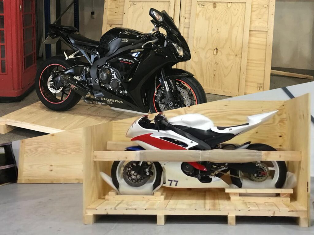 A motorcycle being packed into a shipping crate