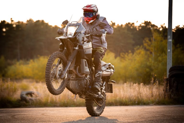 motorcyclist performs wheelie on highway